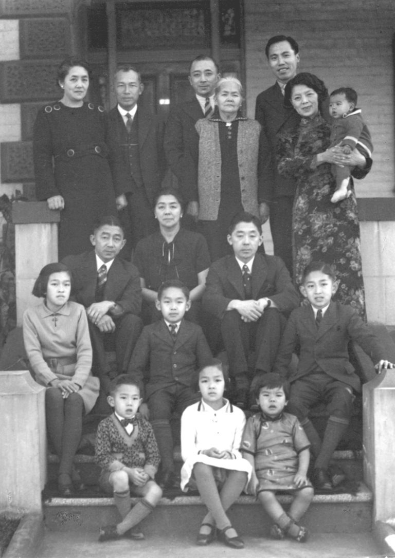 Multi-generational family portrait on the steps of a Haymarket building